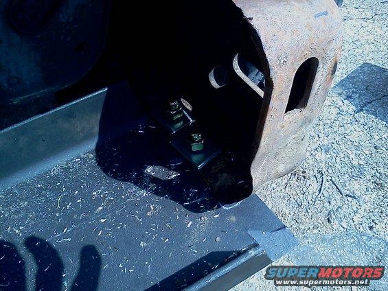Winch mount hardware with bolts and nuts attached to a metal bracket