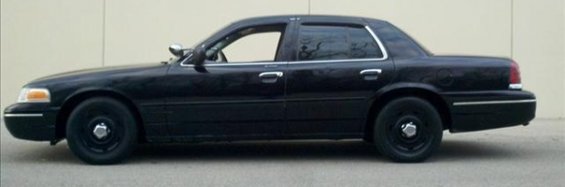 Black 2004 Ford Crown Victoria sedan, side view