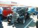 1995 Ford Crown Victoria - A black 1931 Ford Model A Coupe is displayed with its hood open, parked next to other classic cars.
