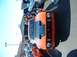 1995 Ford Crown Victoria - This orange sports car features a distinctive black hood and grille, seen from the front.