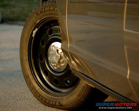 2005 Ford Crown Victoria side view with Firestone tire and Ford hubcap