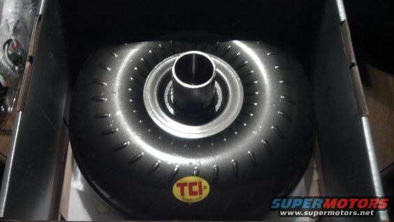 TCI torque converter in a box, showing the front with a metal hub and a circular pattern of studs