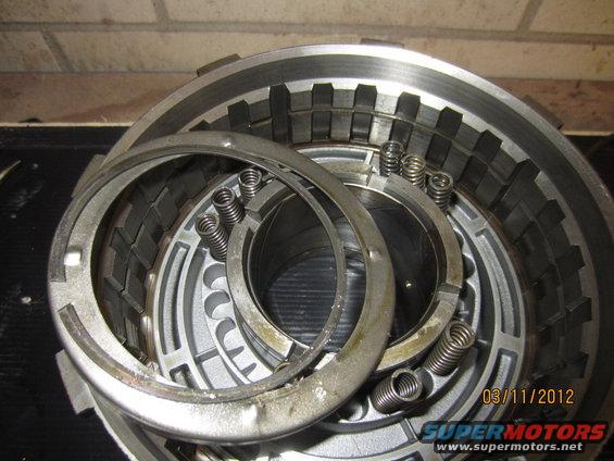 Transmission clutch pack with springs and metal plates