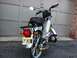 1999 Tomos Targa - Rear view of a silver moped parked in front of a garage door, displaying a New Jersey license plate.