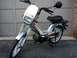 1999 Tomos Targa - A silver Tomos Targa moped is parked in front of a garage door, showing its 'Targa' and 'Tomos' branding.