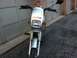 1999 Tomos Targa - Front view of a silver moped, a prominent "TOMOS" logo on its fairing.