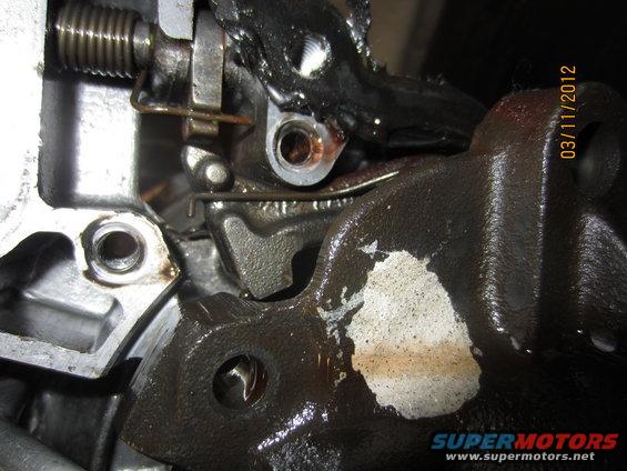 Close-up of a greasy, metallic transmission component with a date stamp