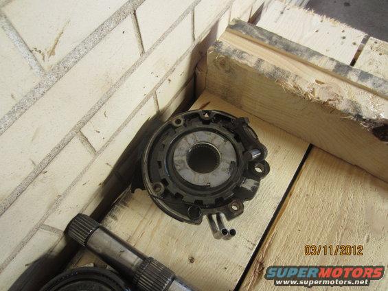Transmission component with splined shaft on wooden surface