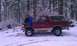 1996 Ford Bronco - A maroon Ford Bronco with a tan top sits in a snowy forest with two children on its hood.