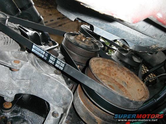 Engine pulleys and serpentine belt system with visible part numbers on the belt