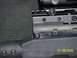 1989 Ford Bronco - A close-up view of a rifle's receiver and scope mount, with a date stamp and website visible.
