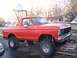 1978 Ford Bronco - A red 1978 Ford Bronco is parked on wooden pallets with a basketball hoop in the background.