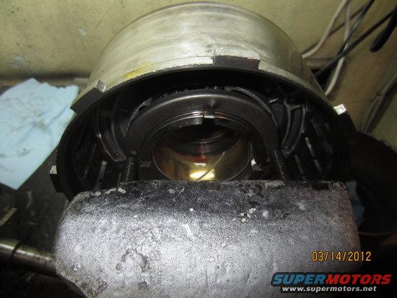 Transmission component held in a vise, showing internal gears and springs
