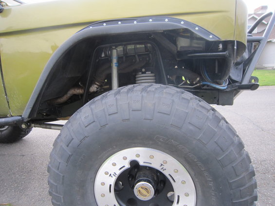 close-up of a large off-road tire and fender well on a modified vehicle