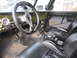 1974 Ford Bronco - Custom interior features a carbon fiber steering wheel, multiple gauges, and bucket seats, suggesting significant modifications.