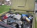 1974 Ford Bronco - Vehicle engine bay with a Ford Mustang fuel injection system and aftermarket air intake installed.