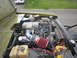 1974 Ford Bronco - The engine bay of a Ford Bronco shows a 5.0 HO engine with various aftermarket modifications.