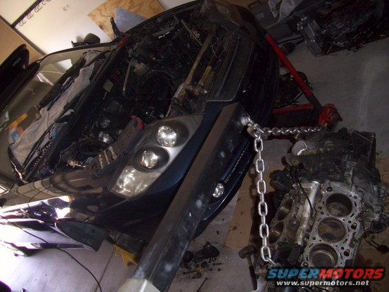 2003 Hyundai Tiburon engine being lifted out with an engine hoist