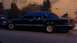 1994 Mercury Grand Marquis - A dark sedan with aftermarket wheels is parked curbside at night.