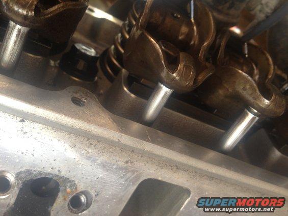 Close-up of engine valve train components, including rocker arms and pushrods