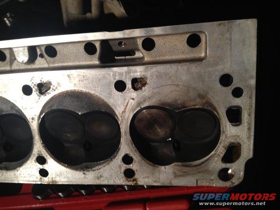 Close-up of an engine cylinder head with visible combustion chambers