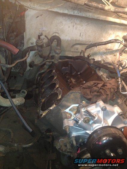 Engine bay with disassembled engine components and hoses