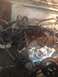 1992 Ford Bronco - Engine bay undergoing repair, showing disassembled engine parts and various hoses and wiring.