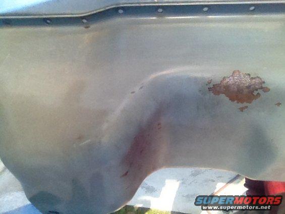 Oil pan with rust spots and red staining