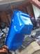 1992 Ford Bronco - Oil pan painted blue and suspended for work in a garage setting.