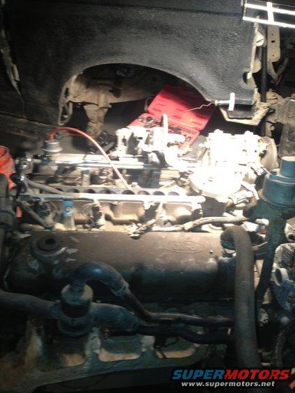 Ford engine with carburetor and red battery