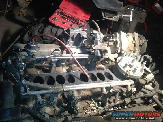 Engine motor parts with a red toolbox on top