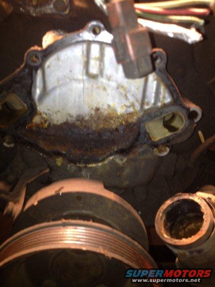 Corroded engine water pump housing with pulley and hose connection