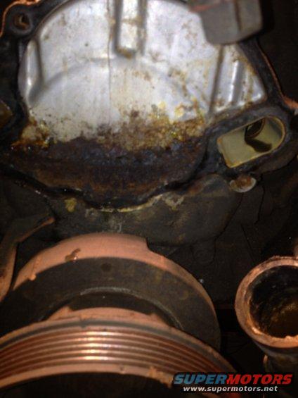 Corroded engine water pump with pulley visible below