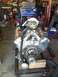 1992 Ford Bronco - A polished V8 engine sits on a stand in a garage, ready for installation or rebuild.