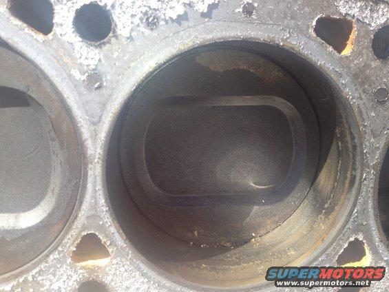 Engine cylinder with piston impression