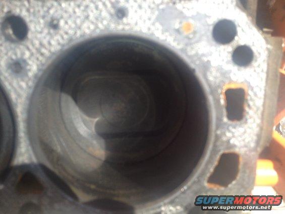 Close-up of an engine cylinder block with visible rust