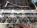 1992 Ford Bronco - Close-up view of an engine's cylinder head during a rebuild, with tools and internal parts visible.
