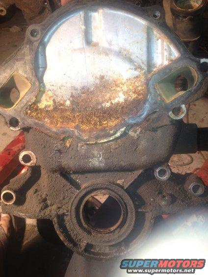 Corroded metal water pump housing with gasket residue and dirt