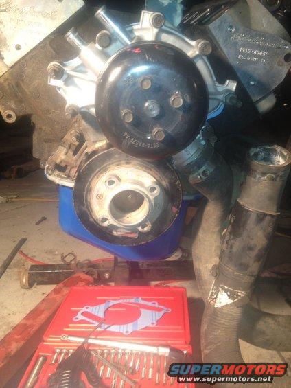 Engine water pump and pulley with part number visible