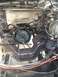 1992 Ford Bronco - This image shows the engine bay of a vehicle during a motor rebuild, with the transmission and frame components clearly visible.