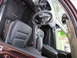 2012 Dodge Durango - The interior of a maroon SUV shows black leather seats and a detailed dashboard with a steering wheel.