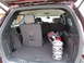 2012 Dodge Durango - The cargo area of the SUV contains a golf bag and stroller wheels, with the rear seats folded down.
