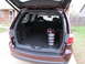 2012 Dodge Durango - The rear view of a maroon SUV shows its cargo area with golf equipment and stroller wheels.