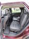 2012 Dodge Durango - The spacious interior of a maroon SUV features comfortable leather seating and a child car seat, ready for family travel.