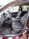 2012 Dodge Durango - The interior of a Dodge Durango shows black leather seats and the dashboard from the passenger side.