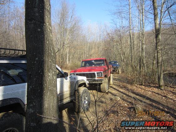 1979 Ford Bronco front grille, red pickup truck on dirt road