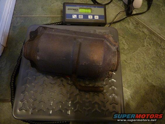 Catalytic converter on a scale with a Dymo scale showing 3.15 kg