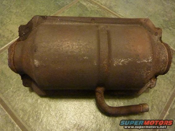 Rusty catalytic converter with 'CA/CE 22' stamped on its side