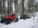 1994 Ford Bronco - Several off-road vehicles navigate a snow-covered forest trail.