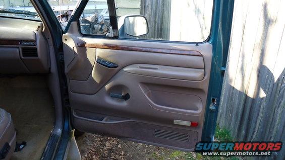 1996 Ford Bronco interior door panel with wood trim and power window controls